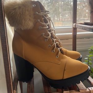 Brown heeled boots with fur.